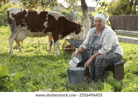 Similar – Image, Stock Photo Woman pouring fresh milk from bottle to enamel mug while having refreshment in garden