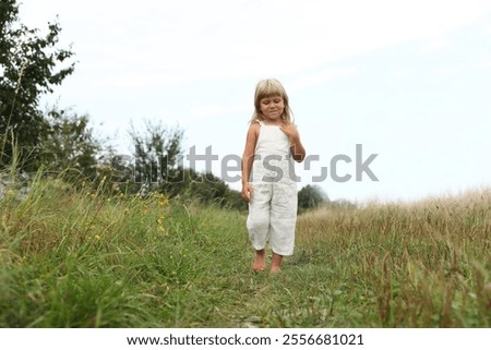 Similar – Image, Stock Photo Little girls walking barefoot on the sand and caring a picnic basket together. Summer leisure, love and friendship.