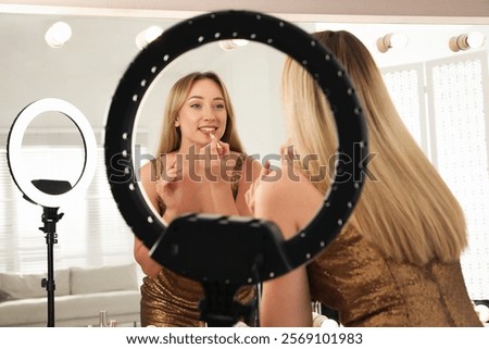 Similar – Image, Stock Photo Woman applying lipstick near car mirror