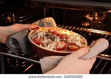 Similar – Image, Stock Photo Casserole is put in the oven