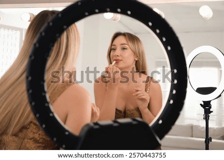 Similar – Image, Stock Photo Woman applying lipstick near car mirror