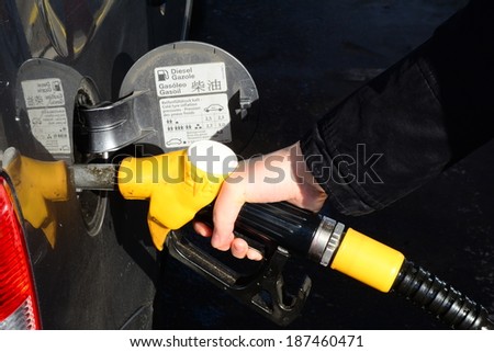 Strasbourg, France 14 February 2014: A woman pumping gas in to the tank