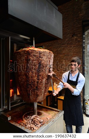 Istanbul, Turkey 03 May 2014: A chef cutting traditional Turkish food Doner Kebab in the restaurant.
