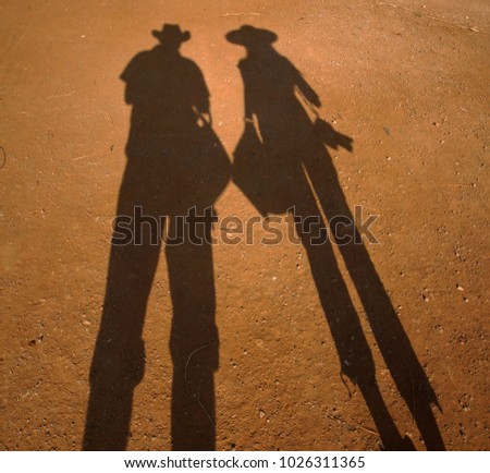 Similar – Image, Stock Photo Two long shadows on asphalt path along a lake shore
