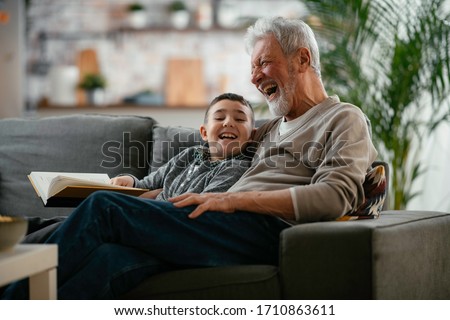 Similar – Image, Stock Photo Grandpa and grandson sitting on a bench in the forest