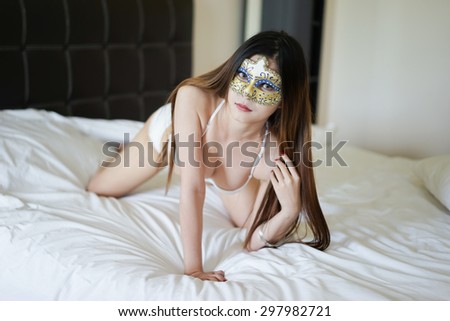 Young beautiful Asian woman in  bikini mask