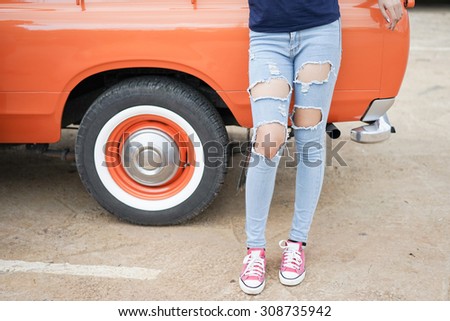 A beautiful woman with her old pickup truck