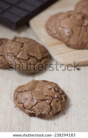 Hot cocoa cookies laid out on a cutting board and counter top.