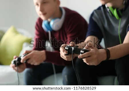 Similar – Image, Stock Photo Children playing video game in bed