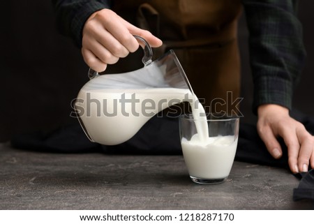 Similar – Image, Stock Photo Woman pouring fresh milk from bottle to enamel mug while having refreshment in garden