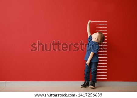 Little boy measuring height near color wall ストックフォト © 