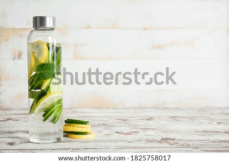 Image, Stock Photo Tasty infused water in bottle with drinking straw and ingredients: lime, strawberry and mint leaves at white background