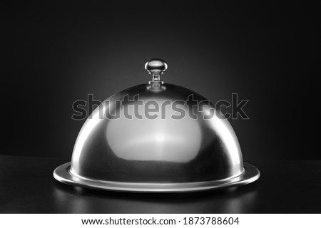 Tray and cloche on dark background Photo stock © 