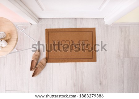 Door mat with shoes in hallway