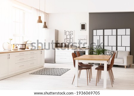Stylish interior of modern kitchen with dining table