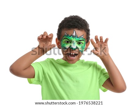 Funny African-American boy with face painting on white background