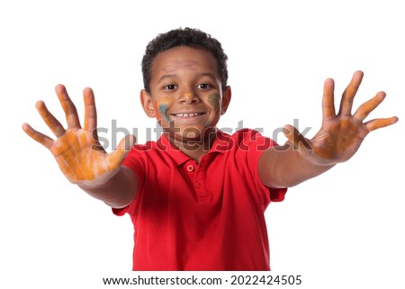 Little African-American boy in paint on white background