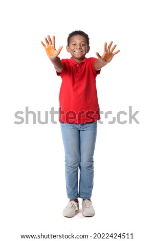 Little African-American boy in paint on white background
