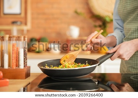 Similar – Image, Stock Photo Pan with rice and beans decorated with chopped green chilies and served on a wooden table