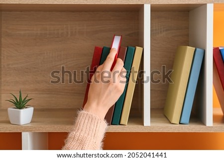 Similar – Image, Stock Photo Woman taking books out of cardboox. Unpacking parcel