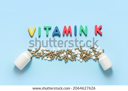 Composition with word VITAMIN K and pills on color background Stock fotó © 