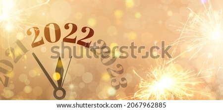 Clock with figures denoting different years on color background. New Year 2022 celebration