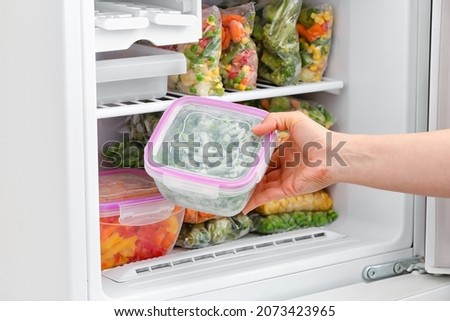 Woman putting cooked cut potato into bowl