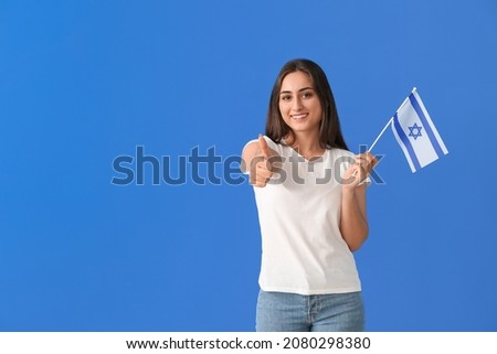 Young woman with the flag of Israel showing thumb-up on color background Stok fotoğraf © 