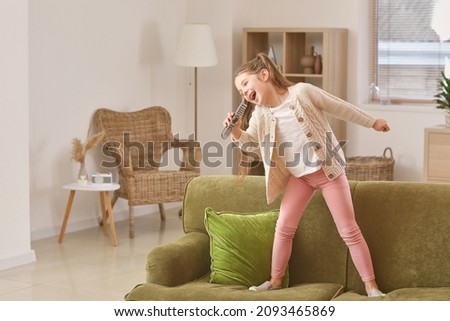 Similar – Image, Stock Photo Little girl singing dancing imitating herself a real singer