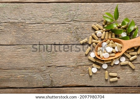Spoon with vitamin K pills on wooden background Stock fotó © 