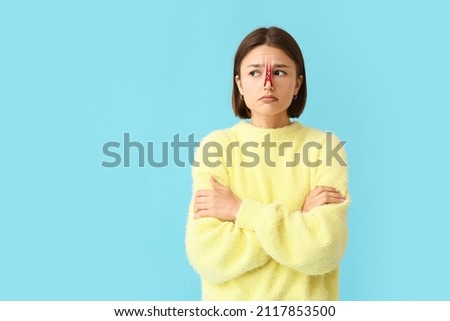 Ill young woman with clothespin on her nose against color background Foto stock © 