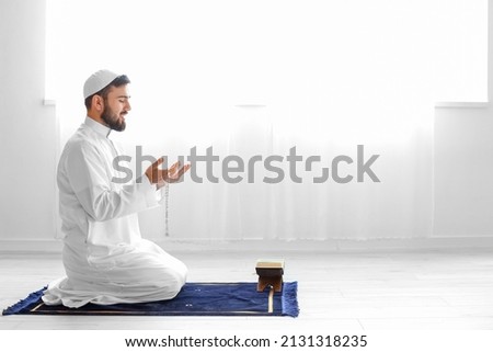 Praying young Muslim man at home Imagine de stoc © 
