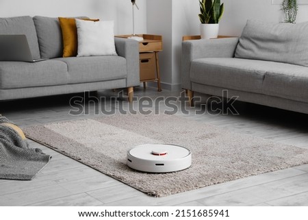 Similar – Image, Stock Photo A robot vacuum cleaner cleans the apartment diligently and independently and makes household chores easier