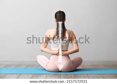 Young woman practicing yoga in gym. Concept of healthy spine Foto stock © 