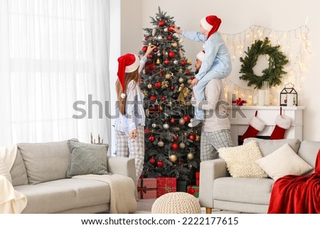 Similar – Image, Stock Photo Boy decorating Christmas tree in evening