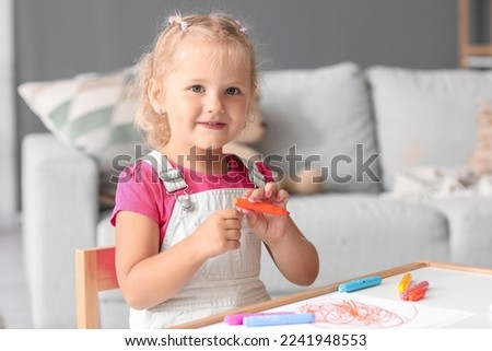 Similar – Image, Stock Photo Little girl preschooler painting a picture using colorful paints and crayons. Child having fun making a picture during an art class in the classroom