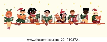 Group of little children in winter clothes reading Christmas sto