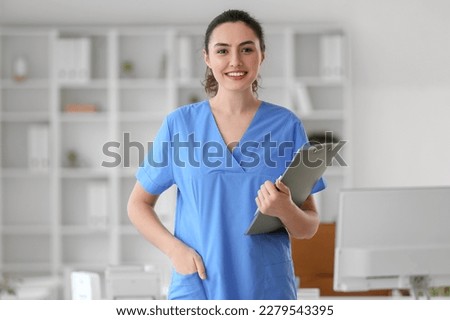 Female medical assistant with clipboard in clinic 商業照片 © 