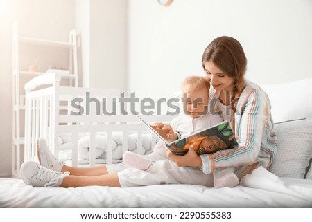 Similar – Image, Stock Photo Mother reading book her daughter in bed before going to sleep. Bedtime stories for child