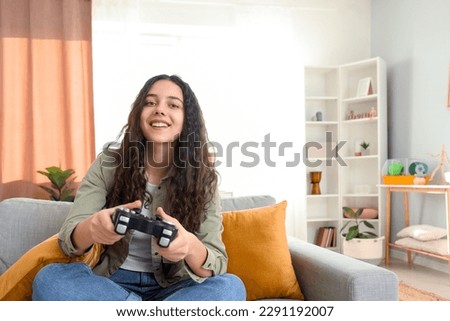 Similar – Image, Stock Photo Happy girl playing video games at night