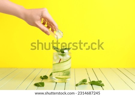 Similar – Image, Stock Photo Woman adding ice in splashing cocktail