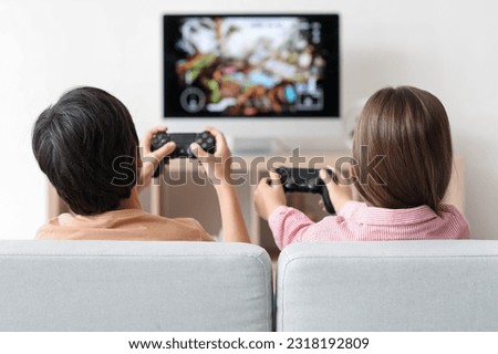 Similar – Image, Stock Photo Happy girl playing video games at night