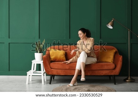 Image, Stock Photo Woman sitting on red suitcase on road