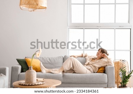 Similar – Image, Stock Photo Young woman lies on a bale of straw in the field and smiles