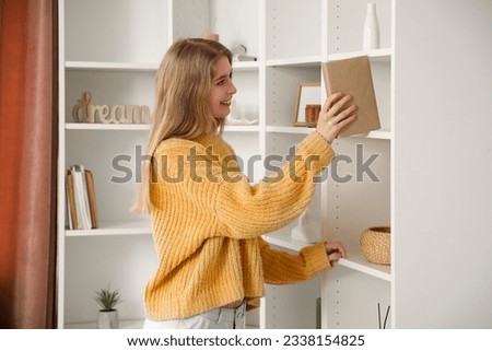 Similar – Image, Stock Photo Woman taking books out of cardboox. Unpacking parcel