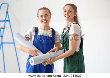 Female decorators with wallpaper rolls in room Stock fotó © 