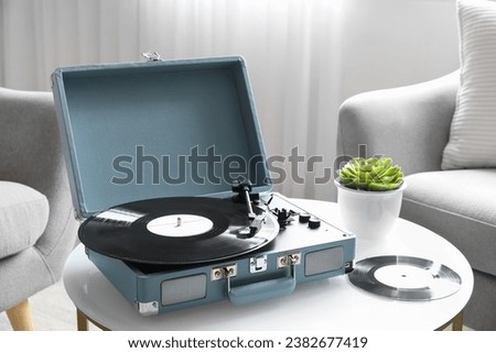 Similar – Image, Stock Photo Vintage vinyl records player at home with a green plant in the evening with warm lamp light