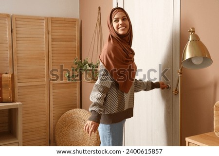 Similar – Image, Stock Photo Young arab woman opening a box with products while smiling, concept retail and buying online