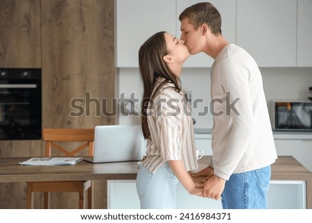 Similar – Image, Stock Photo Couple kissing in kitchen on counter