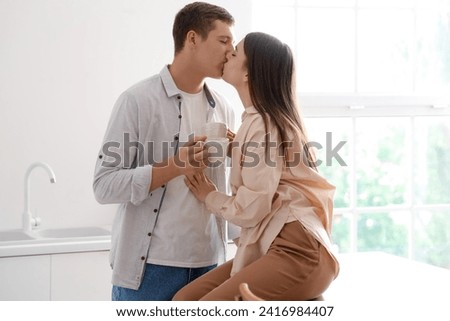 Similar – Image, Stock Photo Couple kissing in kitchen on counter